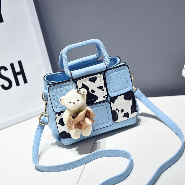 Μια μικρή τσάντα με αξεσουάρ αρκούδα σε γκρι, κόκκινο, μπλε, μοβ και ροζ