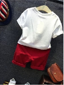 Интересен детски комплект за момчета-тениска с пера и червени къси панталони.