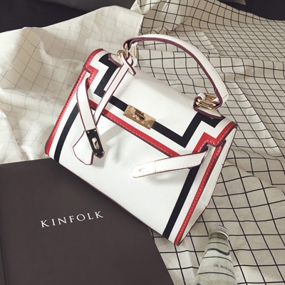 Стилна дамска чанта в черно и бяло с интересно закопчаване. 