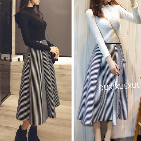 Οι γυναίκες το κομψό σετ με μαύρη κορυφή και φούστα των λωρίδων.